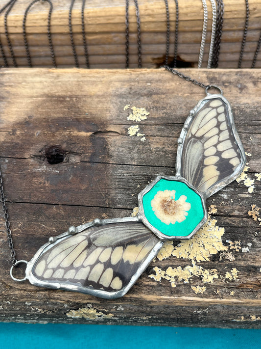 Ethically Sourced Butterfly Wing Necklace with Feverfew on Green Background – Nature Statement Jewelry